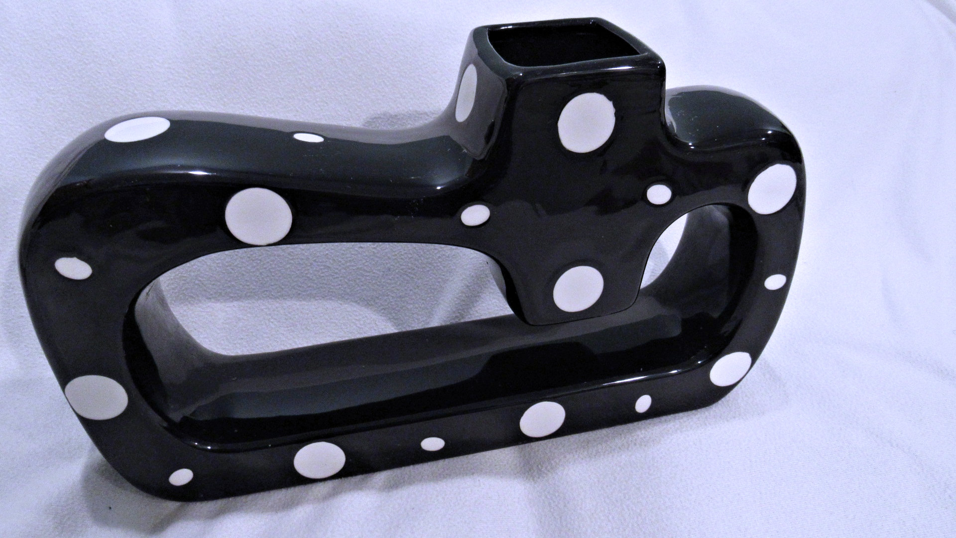 Black Ceramic Vase with White Polka Dots and Smooth Surface.